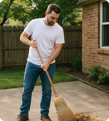 Worker sweeping the yard